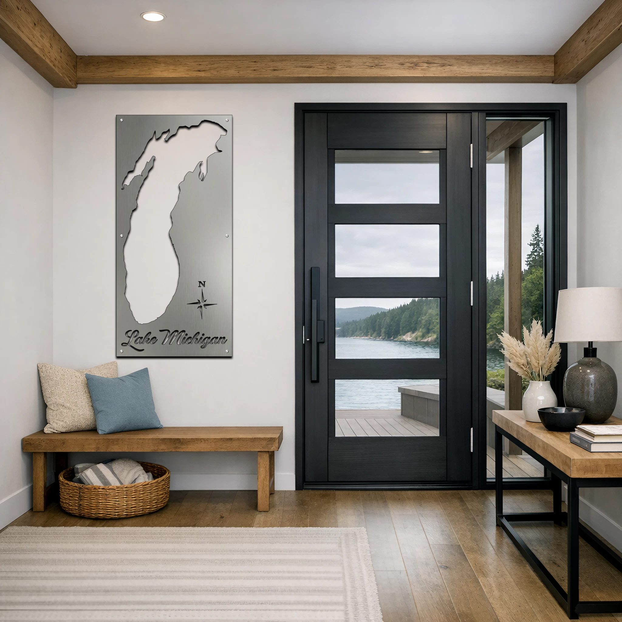 Metal map of Lake Michigan hangs on the wall in a modern entryway with a view of the lake.
