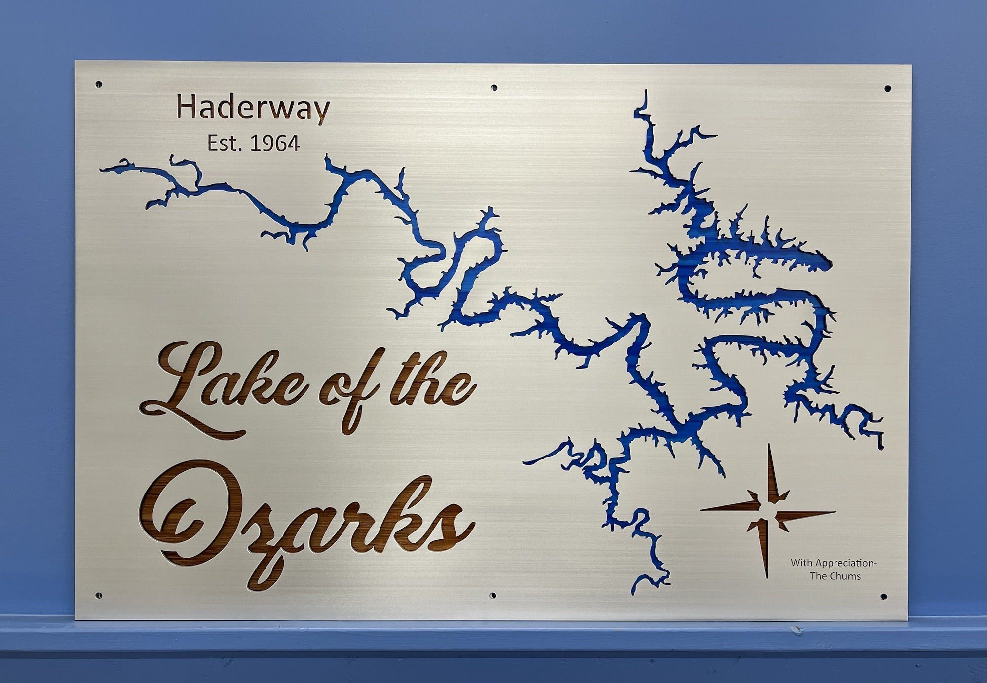 Lake of the Ozarks metal map with "Haderway Est. 1964" text, featuring a compass rose and blue detailing on a silver background.