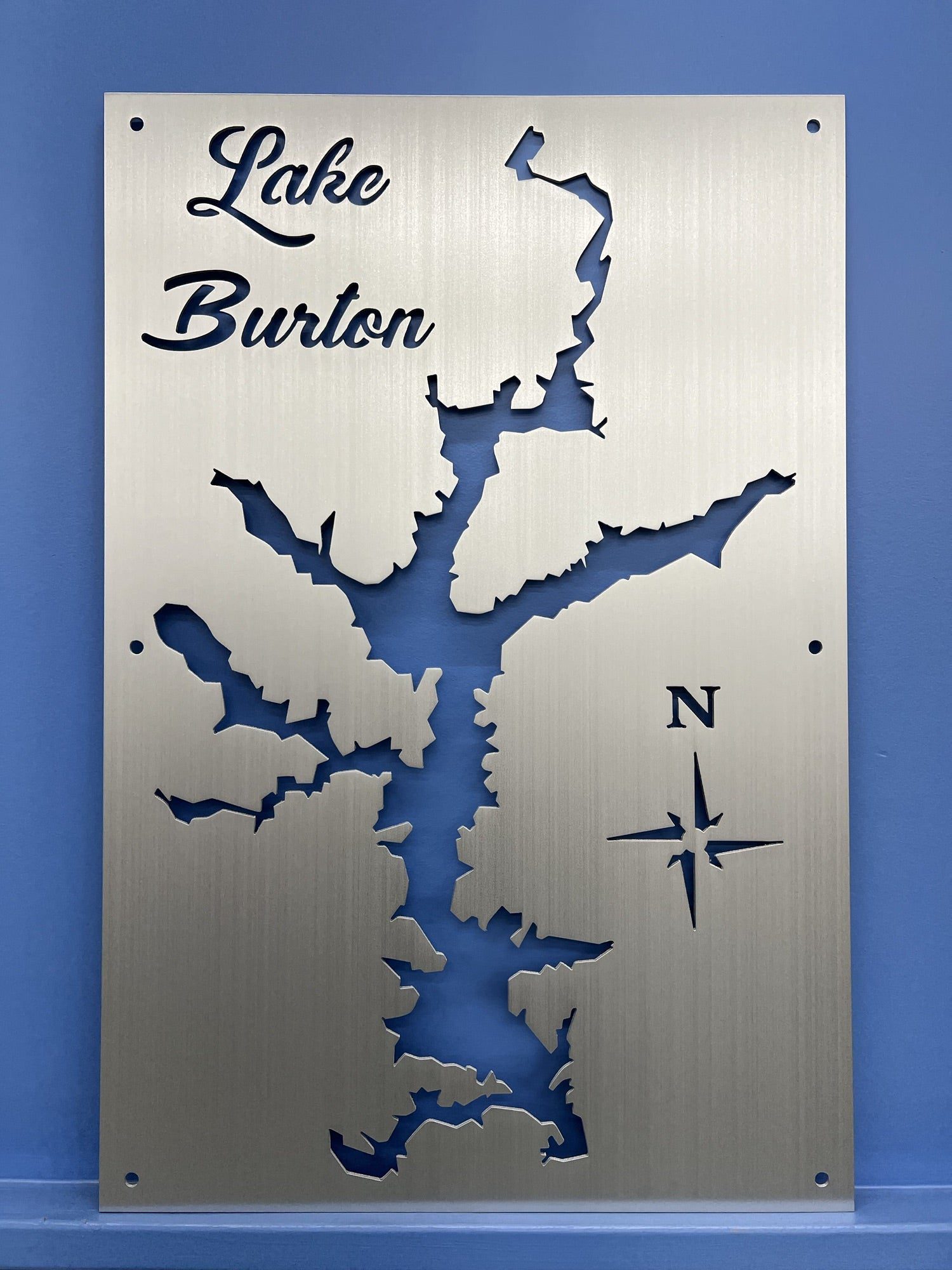 Brushed metal Lake Burton map with decorative script and compass rose, mounted on a blue background.