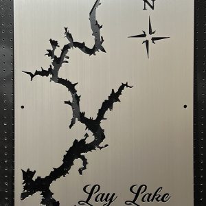 Lay Lake cutout metal map with compass rose, mounted on a black pegboard.