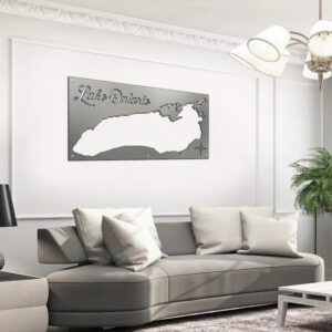 Metal map of Lake Ontario displayed on a wall above a gray sofa with cushions in a modern living room.