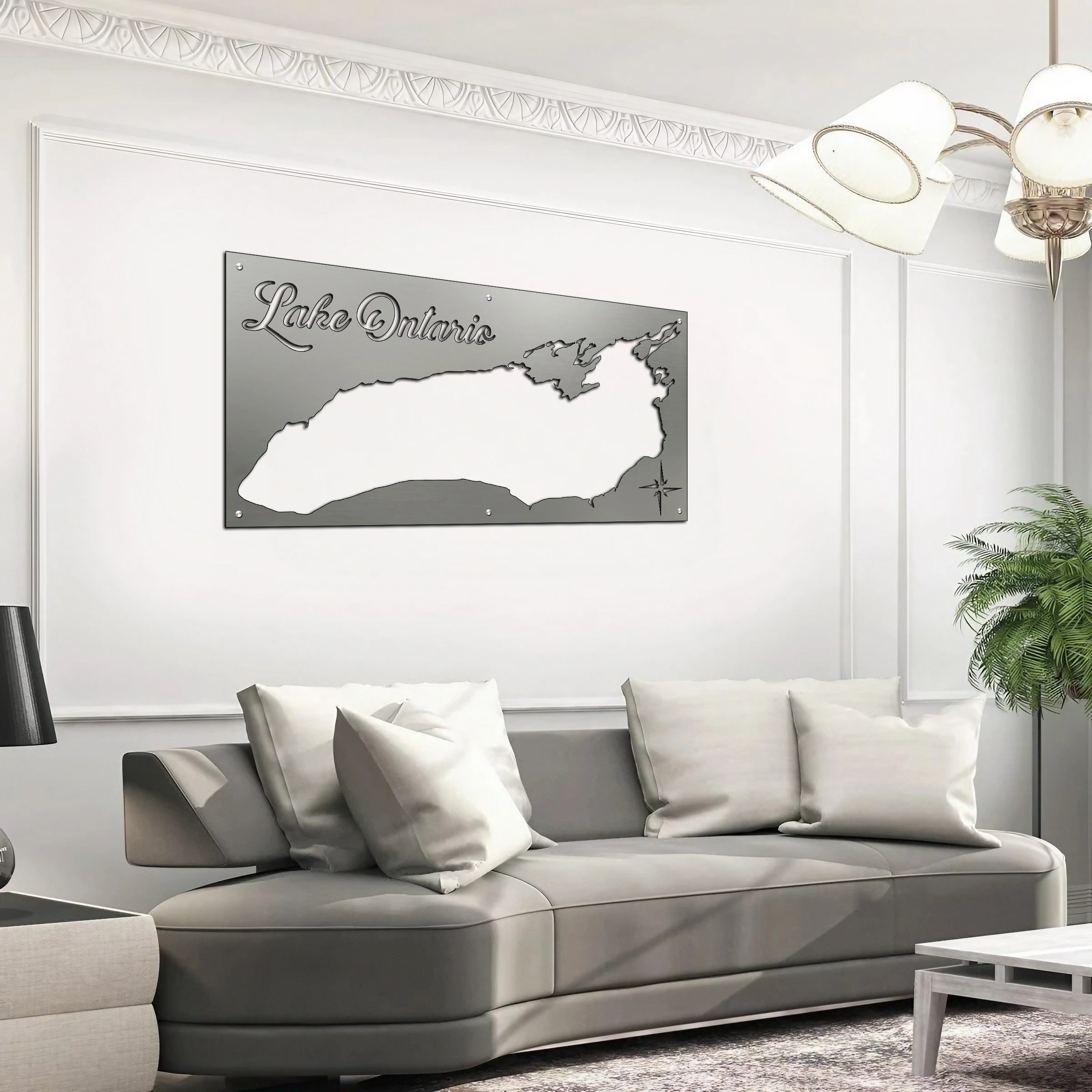 Metal map of Lake Ontario displayed on a wall above a gray sofa with cushions in a modern living room.