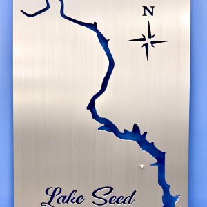 Metal sign depicting the outline of Lake Seed with a compass rose and the text "Lake Seed" at the bottom.