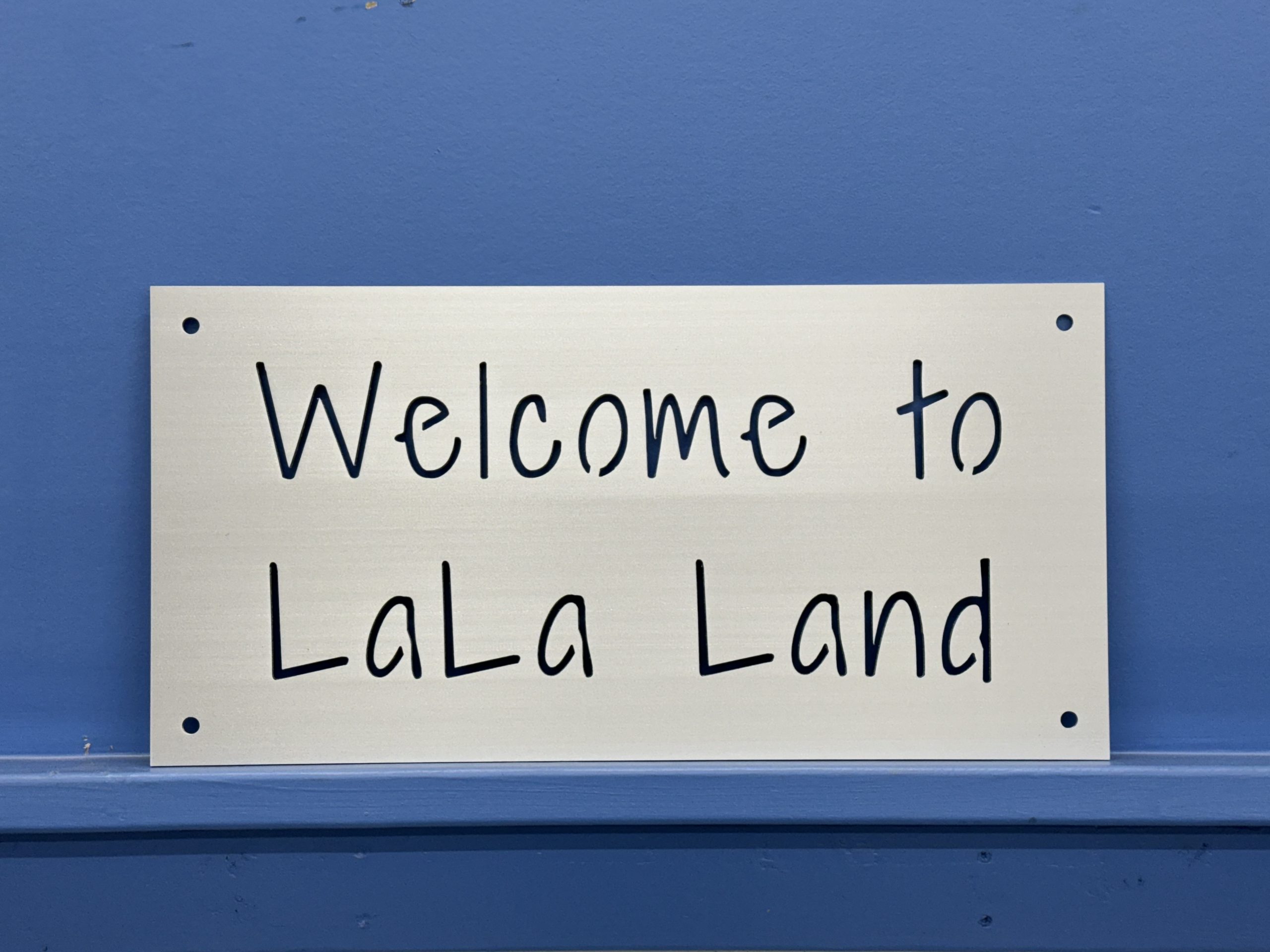 Custom brushed metal sign reading Welcome to LaLa Land.