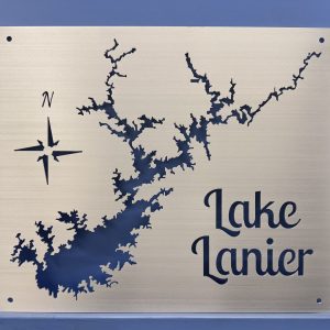 Lake Lanier brushed metal map with compass rose and open shoreline cutouts, shown without a backplate against a blue wall.