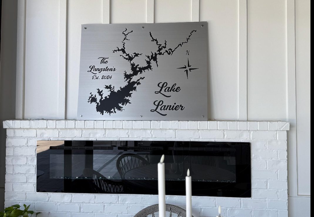Personalized Lake Lanier family map displayed above a fireplace.